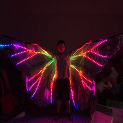 Plasma Dragon LED Wings in rainbow lights, worn at an angle in a dark venue