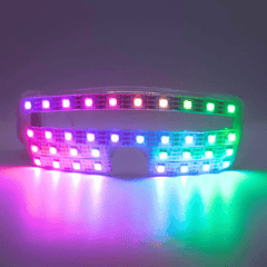 NeuroGlow LED Glasses (Performer Grade) lit up in rainbow pixels, front view in the dark