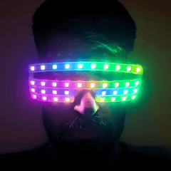NeuroGlow LED Glasses worn and lit up in pink, blue and green across the visor