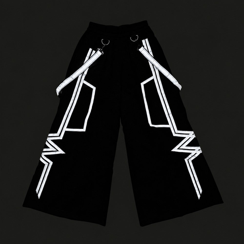 White Tron Phat Pants with silver-white reflective angular strips and suspenders on black fabric