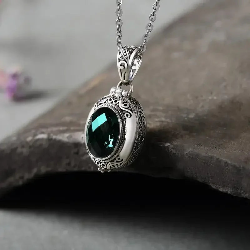 Oval locket necklace in Green, teal stone in an ornate silver-tone frame on its chain