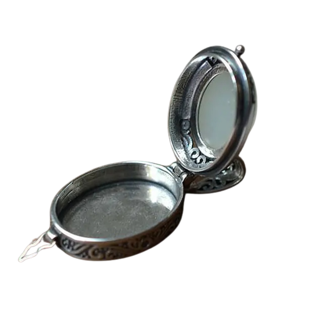 Oval locket necklace with its hinged front open to show the inside of the locket